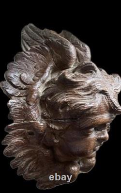 18th-century wooden sculpture of an old religious cherub angel<br/> 