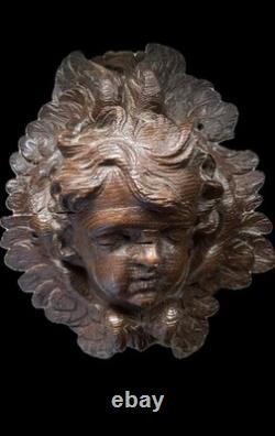 18th-century wooden sculpture of an old religious cherub angel <br/>