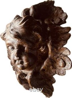 18th-century wooden sculpture of an old religious cherub angel
<br/>
