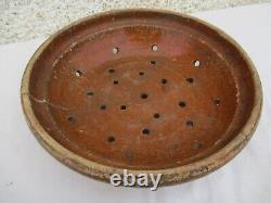 2 Terracotta strainers, 1 glazed cream bowl and skimmer, 19th Century