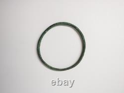 Ancient bronze bangle bracelet decorated with geometric motifs, Roman era