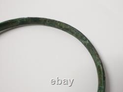 Ancient bronze bangle bracelet decorated with geometric motifs, Roman era