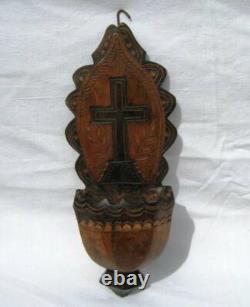 Ancient wooden monoxyle holy water font popular art cross