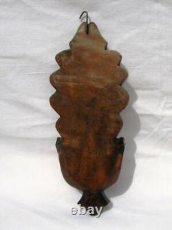 Ancient wooden monoxyle holy water font with popular art cross