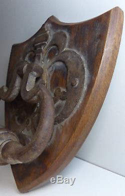 Antique Iron Door Knocker Mounted On A Wooden Shield