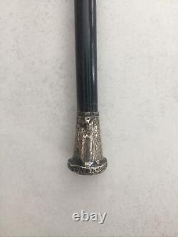 Antique cane with silver pommel and chiseled motifs, Milord cane from the 19th century.