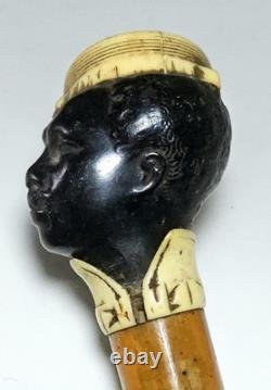 Antique dandy’s cane, late 19th century, ebony carved handle with a black man’s head pommel