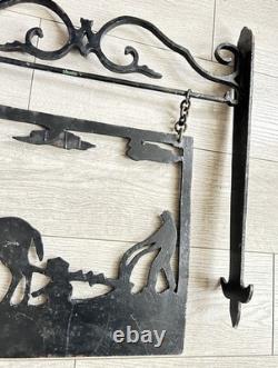 Antique wrought iron sign depicting a plowman