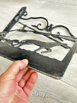 Antique wrought iron sign depicting a plowman