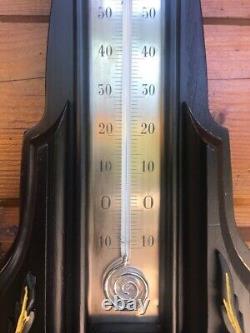 Bourdon barometer on blackened wood and mercury thermometer