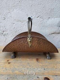 Copper log holder with lion feet. Ceramic handle