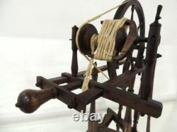 Large wool spinning wheel and its miniature, 19th-century folk art