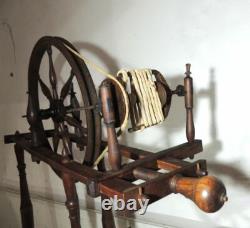 Large wool spinning wheel and its miniature, 19th-century folk art