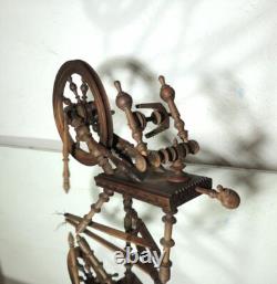 Large wool spinning wheel and its miniature, 19th-century folk art