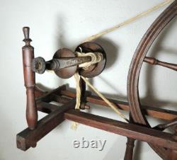 Large wool spinning wheel and its miniature, 19th-century folk art