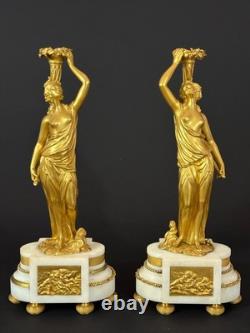 Old pair of gilt bronze candlesticks with female figure and cornucopia, 19th century