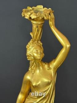 Old pair of gilt bronze candlesticks with female figure and cornucopia, 19th century