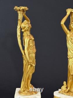 Old pair of gilt bronze candlesticks with female figure and cornucopia, 19th century