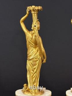 Old pair of gilt bronze candlesticks with female figure and cornucopia, 19th century