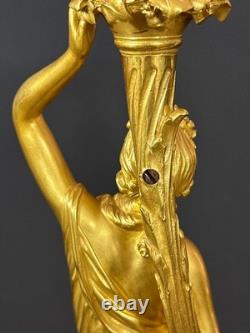 Old pair of gilt bronze candlesticks with female figure and cornucopia, 19th century