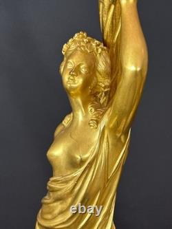 Old pair of gilt bronze candlesticks with female figure and cornucopia, 19th century