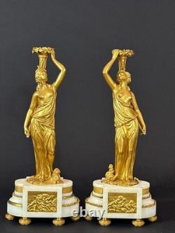 Old pair of gilt bronze candlesticks with female figure and cornucopia, 19th century