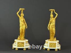 Old pair of gilt bronze candlesticks with female figure and cornucopia, 19th century