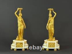 Old pair of gilt bronze candlesticks with female figure and cornucopia, 19th century