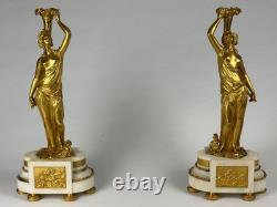 Old pair of gilt bronze candlesticks with female figure and cornucopia, 19th century