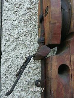 Old wooden and iron pulley from the 19th century