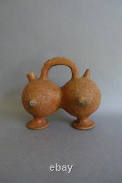 Terracotta whistling vase with incised decoration