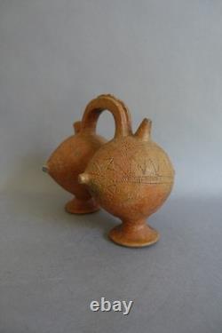 Terracotta whistling vase with incised decoration