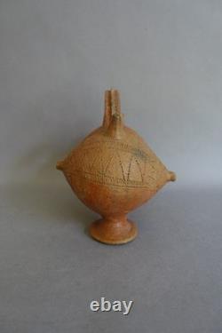 Terracotta whistling vase with incised decoration