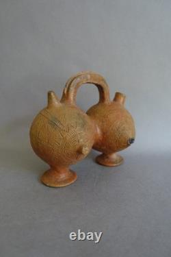 Terracotta whistling vase with incised decoration