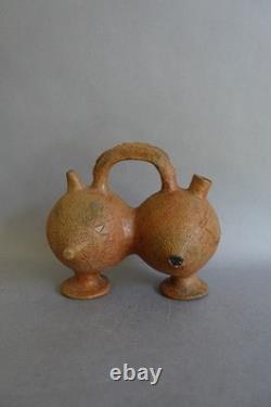 Terracotta whistling vase with incised decoration