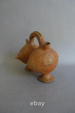 Terracotta whistling vase with incised decoration
