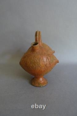 Terracotta whistling vase with incised decoration
