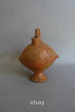 Terracotta whistling vase with incised decoration