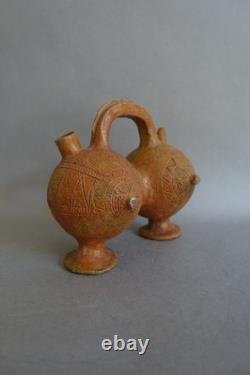 Terracotta whistling vase with incised decoration