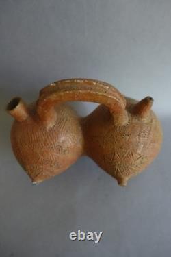Terracotta whistling vase with incised decoration