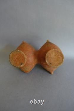 Terracotta whistling vase with incised decoration