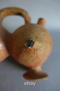 Terracotta whistling vase with incised decoration