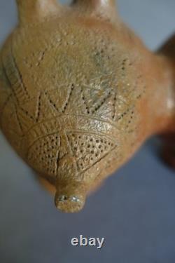 Terracotta whistling vase with incised decoration