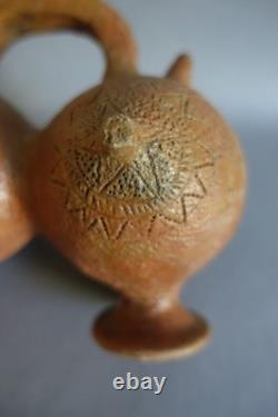Terracotta whistling vase with incised decoration