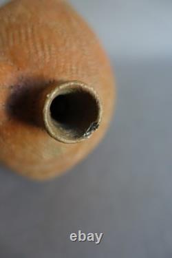 Terracotta whistling vase with incised decoration