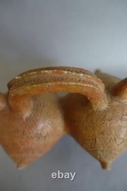 Terracotta whistling vase with incised decoration