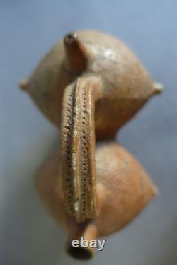 Terracotta whistling vase with incised decoration