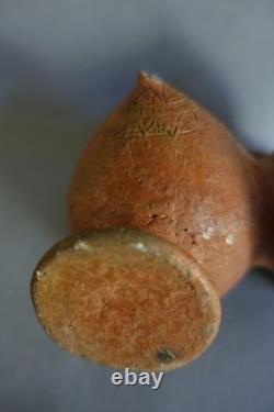Terracotta whistling vase with incised decoration