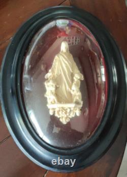 ANCIEN RELICAIRE Cadre ovale en bois Napoléon III noirci, et verre bombé